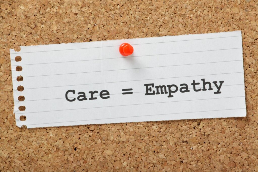 Note on board that says care = empathy